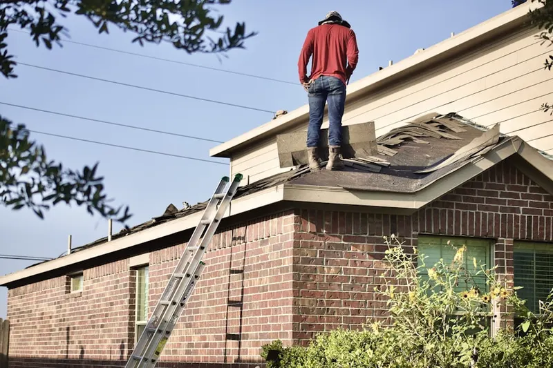 Professional roofer working on a residential roof in Wheatfield Way